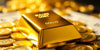 Gold bullion bar and coins on a luxurious surface.