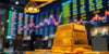 Close-up of gold bars in a trading environment.