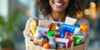 Person joyfully holding a shopping bag with products.