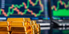 Close-up of gold bars on a trading desk.