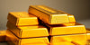 Close-up of stacked gold bullion bars.