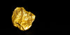 Close-up of a gold nugget on a textured surface.