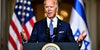 President Biden at a podium with US and Israel flags.